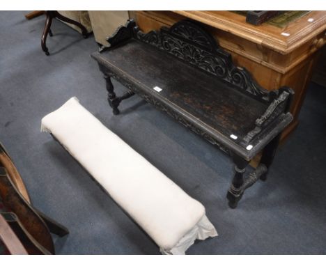 A VICTORIAN CARVED OAK HALL BENCH and a similar long footstool (2)