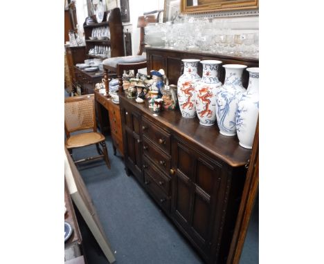 A DARK STAINED ERCOL SIDEBOARD and two Victorian chairs