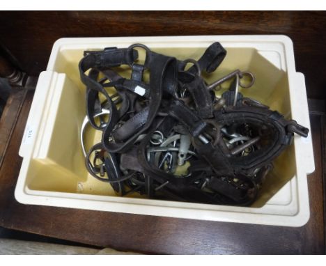 A COLLECTION OF VINTAGE HORSE TACK including leather straps and 'bits'