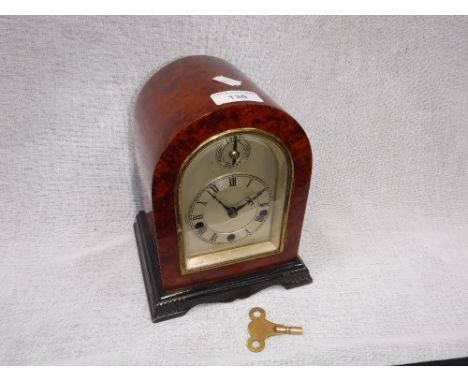 A 20TH CENTURY MANTEL CLOCK, with silvered dial and chime in a burr wood and ebonised case 8.25" high (key in office)
