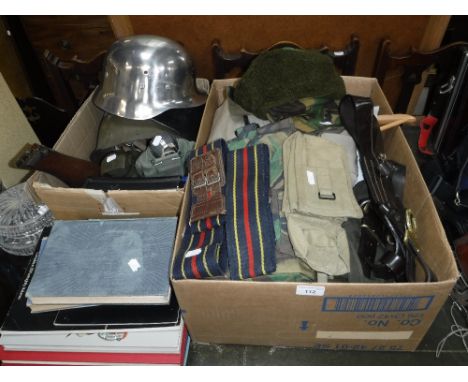 A COLLECTION OF VINTAGE MILITARIA including  three helmets, a vintage leather bomber jacket, a 'jacket gaberdine' with trouse