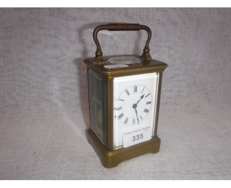 AN M.F. DENT CO. OF LONDON BRASS-CASED CARRIAGE CLOCK, striking on a gong, with a painted enamel dial and bevelled glass pane