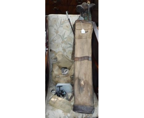 A COLLECTION OF VINTAGE GOLF CLUBS, contained in a vintage leather trimmed bag and a collection of fishing flies and reels (a