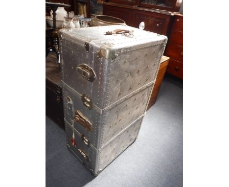 A LARGE VINTAGE ALUMINIUM TRAVELLING TRUNK with blue fabric lined interior 