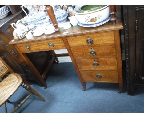 AN EDWARDIAN LIGHT OAK DESK with inset green leather top 29" high x 39" wide