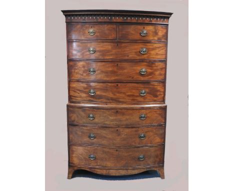 A George III mahogany bowfront chest on chest, late 18th century, with boxwood and ebony faux fluted cornice above arched and