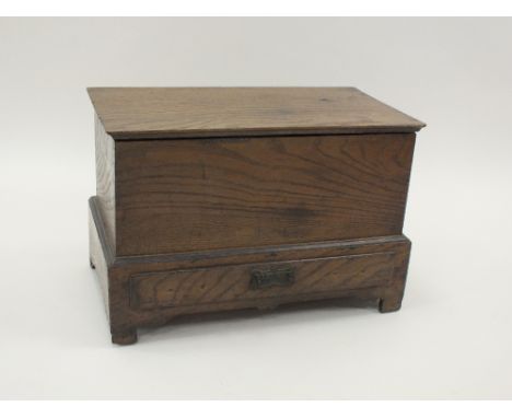 An elm coffer bach 18th century and later, the detachable ogive moulded top above a shallow frieze drawer with Art Nouveau me