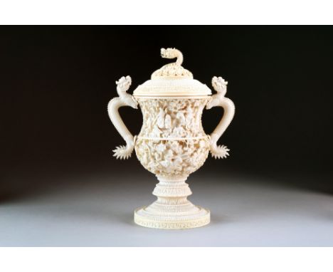 A Chinese Canton carved ivory vase and cover, of campana form with twin dragon handles, the domed cover with a dragon and clo