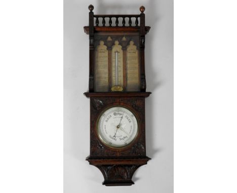 A Victorian oak aneroid barometer, the 7.5 inch silvered register signed 'Dollond, London' the case of Gothic revival design 