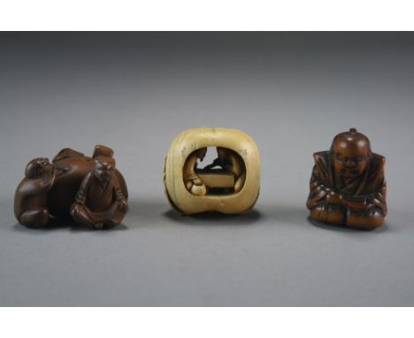 A Japanese ivory netsuke, Meiji period, modelled as a gourd with stem and leaves, open to the middle inside which sit two gen