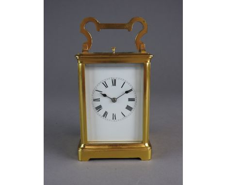 A brass case carriage clock, late 19th/early 20th century, the five glass case enclosing a white enamel dial with Roman numer