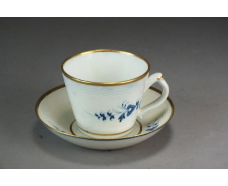 A Caughley coffee cup and saucer painted with Chantilly Sprigs between ozier and gilt borders, unmarked, the cup 6cm high, th