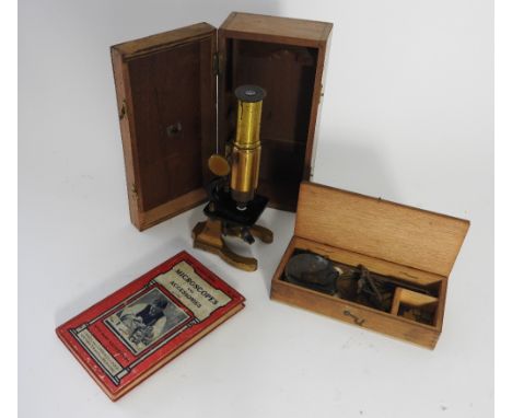 An early 20th century No.28 student's microscope in a wooden case along with a large quantity of botanical slides, plain slid