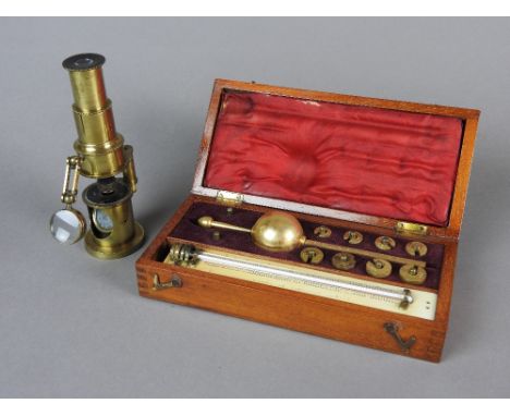 A lacquered brass drum microscope, first half 19th century compound monocular, draw tube focusing triple lens and articulated