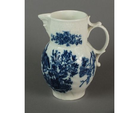 A Caughley mask head cabbage leaf jug transfer-printed in the Parrot Pecking Fruit pattern, circa 1785, unmarked, 19.5cm high
