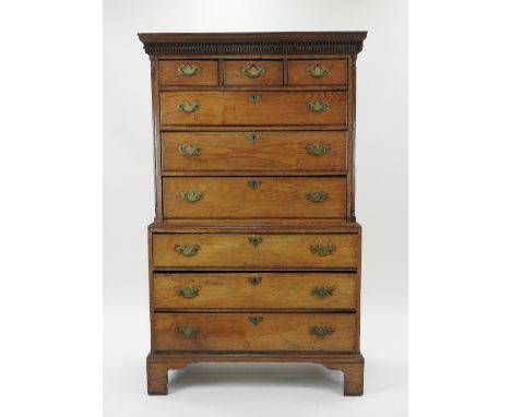 A George III oak chest on chest, the dentil moulded cornice over three short and six long drawers, fitted with replacement br