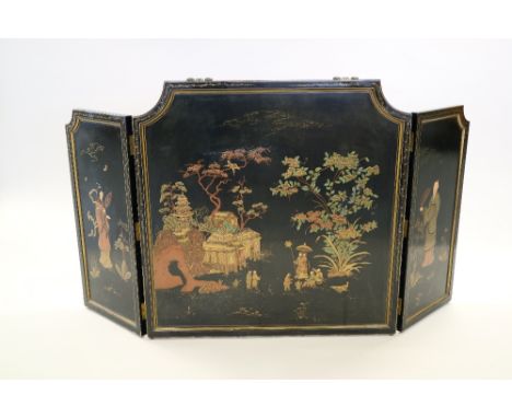 A Chinese lacquer two-fold fire screen, late Qing/Republic, of canted rectangular form and decorated with figures in landscap