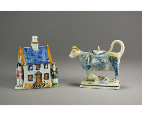 A 19th century prattware money box formed as a house flanked by male and female figures, 13cm high and a 19th century prattwa