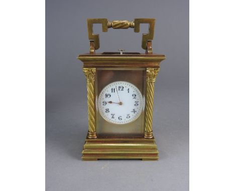 A late 19th century French repeating carriage clock, the circular enamel dial with ring of Arabic numerals, the back plate st