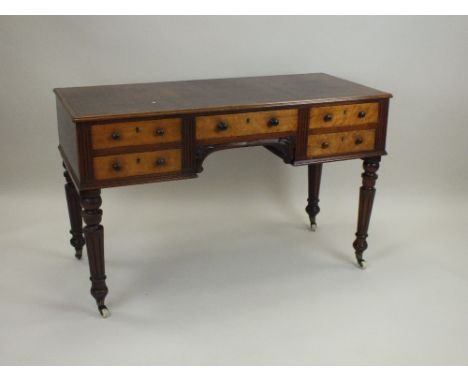 A Victorian mahogany and bird's eye maple fronted wash stand, later converted to a desk, the rectangular bevelled top above a