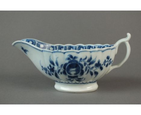 A Caughley sauce boat painted with the rare Rose pattern, circa 1776-1779, reversed C mark, 15cm wide (crack around lower sec