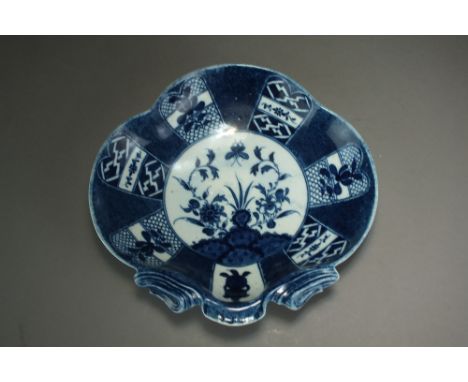 A Caughley powder blue shell form dessert dish in the Holed or Flaming rock pattern, circa 1788-80, C mark, 21.5cm wideEx Rod