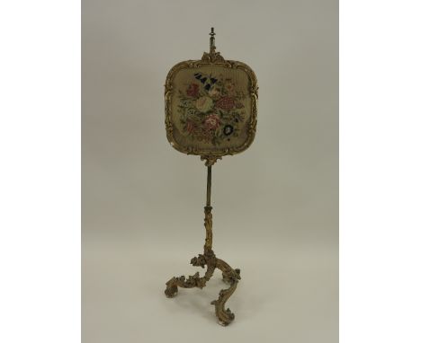A gilt gesso and brass pole screen 19th century with floral tapestry work panel on an adjustable column and three Rococo styl