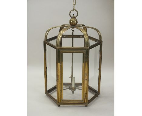 A large brass framed hexagonal hall lantern, 20th century the frame enclosing six candle branches fitted for electricity with