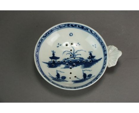 A Caughley egg drainer painted with the Island pattern, circa 1780-90, with an associated segmented border, S mark, 9.5cm dia