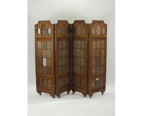 An unusual late Victorian or Edwardian oak three fold room screen for photographs, the four panels divided into glazed openin