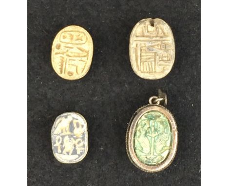 A collection of four Egyptian Scarabs, comprising an 18th Dynasty cream steatite scarab with Tutmosis III cartouche; a 12th D