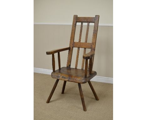 An 18th Century oak Armchair the tapered back with an open frame and upright bars above swept arms over a block seat on stick