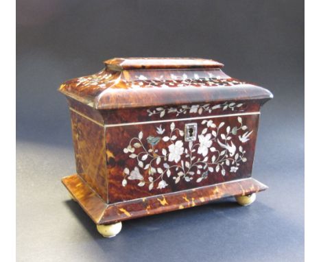 A 19th Century tortoiseshell Tea Caddy of sarcophagus shape with floral inlay, two interior lidded compartments, on turned fe