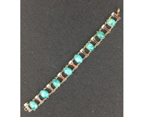 An Egyptian revival faience scarab and enamel Bracelet, composed of eight turquoise coloured scarabs interspersed with nine e