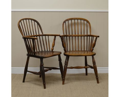 Two 19th Century Windsor Armchairs in ash and elm with stick backs, solid seats on turned legs united by H stretchers