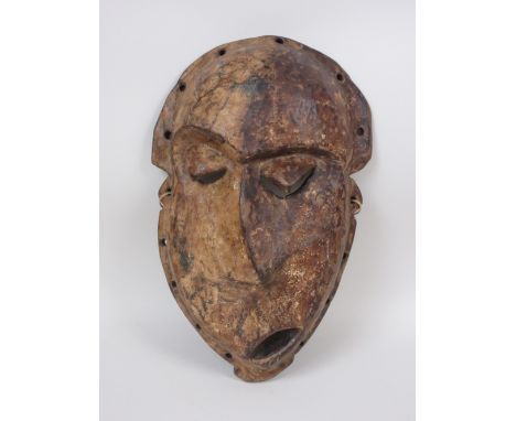 A Pende "Kwese" Mask, wood with dark and light pigment, Congo