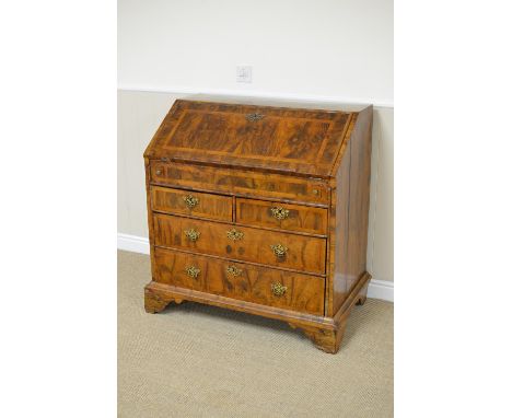 An 18th Century inlaid walnut Bureau, the quartered fall enclosing a stepped interior with well, above two short and two long