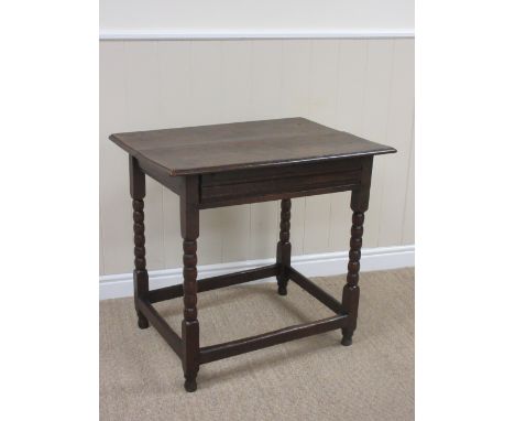 A late 17th Century oak Side Table with two piece top above shallow moulded frieze drawer on bobbin turned and square support
