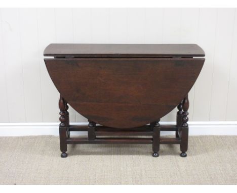 A late 17th Century oak oval Gate-leg Table fitted single drawer on baluster turned and square legs united by square stretche