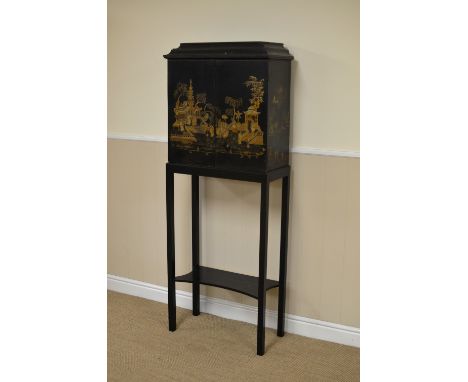 A 19th Century lacquered and gilt chinoiserie decorated Cabinet on Stand, the moulded cornice above a pair of doors enclosing