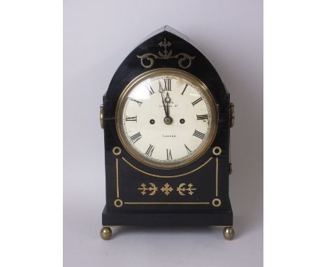 A Regency Bracket Clock with double fusee movement within arched ebonised case with brass inlay and ring handles, mounted upo
