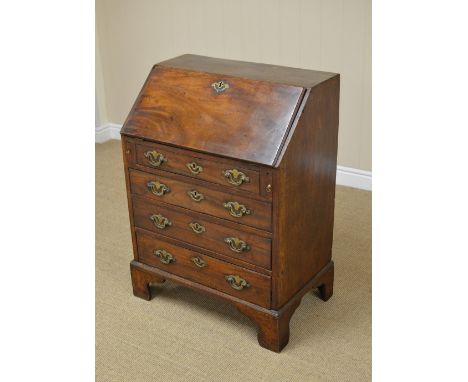 An 18th Century mahogany Bureau, the moulded fall revealing a fitted interior of pigeon holes and drawers around a central do