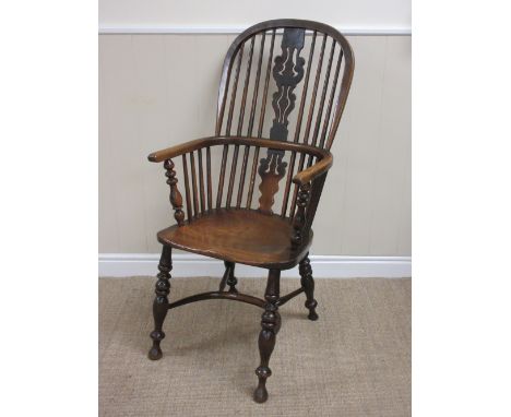 A 19th Century ash and elm Windsor Chair with pierced splat and stick back, solid seat on turned supports united by crinoline