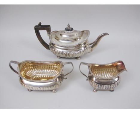 A George III silver three piece Tea Service of boat shape with gadroon embossing on bun feet, London 1810/11, Teapot by Emes 