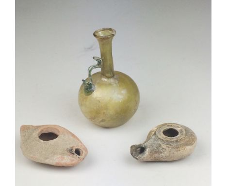 A Roman olive green glass Flask, 3rd-4th Century A.D., with globular body and everted rim, right-angled blue glass handle, 5 