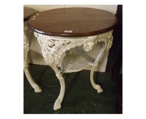 Victorian style white painted cast iron pub table with pierced and mask castings to the three curved legs, which join a pierc