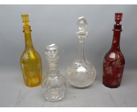 Bohemian red glass ivy leaf etched decanter together with a further matching amber decanter and two clear cut glass decanters