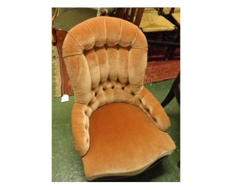19th century mahogany framed nursing chair with puce upholstery on button back, on tapering turned front legs, on brass caste