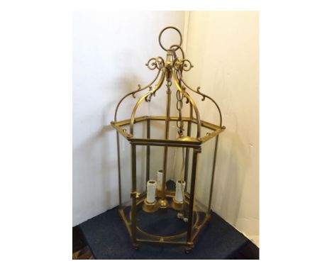 Reproduction brass ceiling lantern with six glass panels and three candle sconces, scrolling supports, 27ins long x 13ins acr
