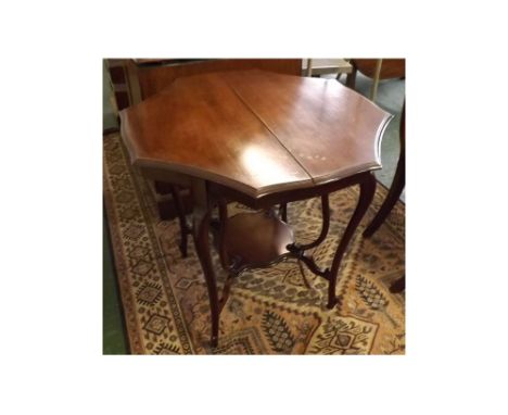 Edwardian mahogany occasional table of concave sided octagonal form, raised on two sets of four curved legs joining a shaped 